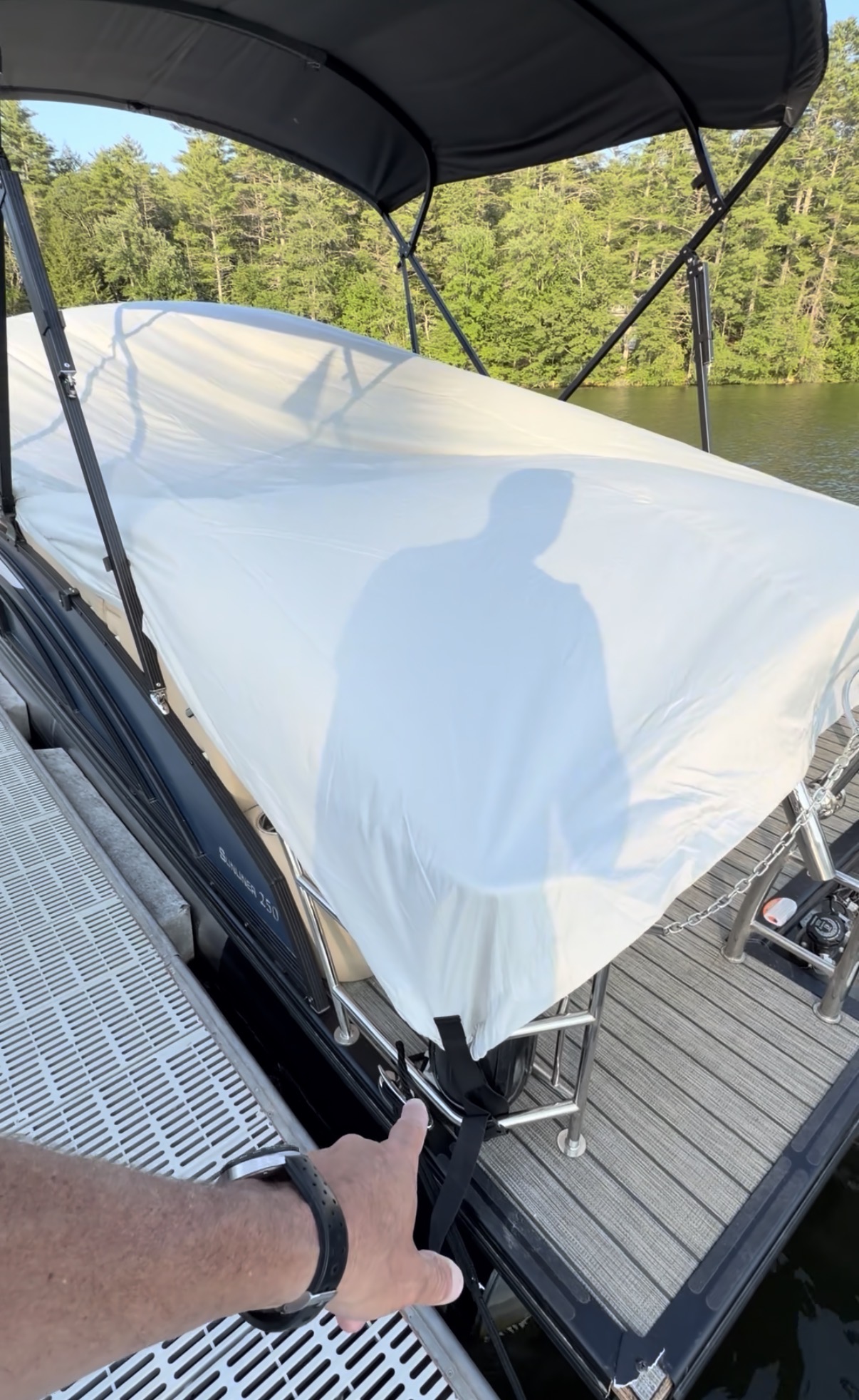 White Quick Boat Cover installed over a Harris pontoon boat at the dock