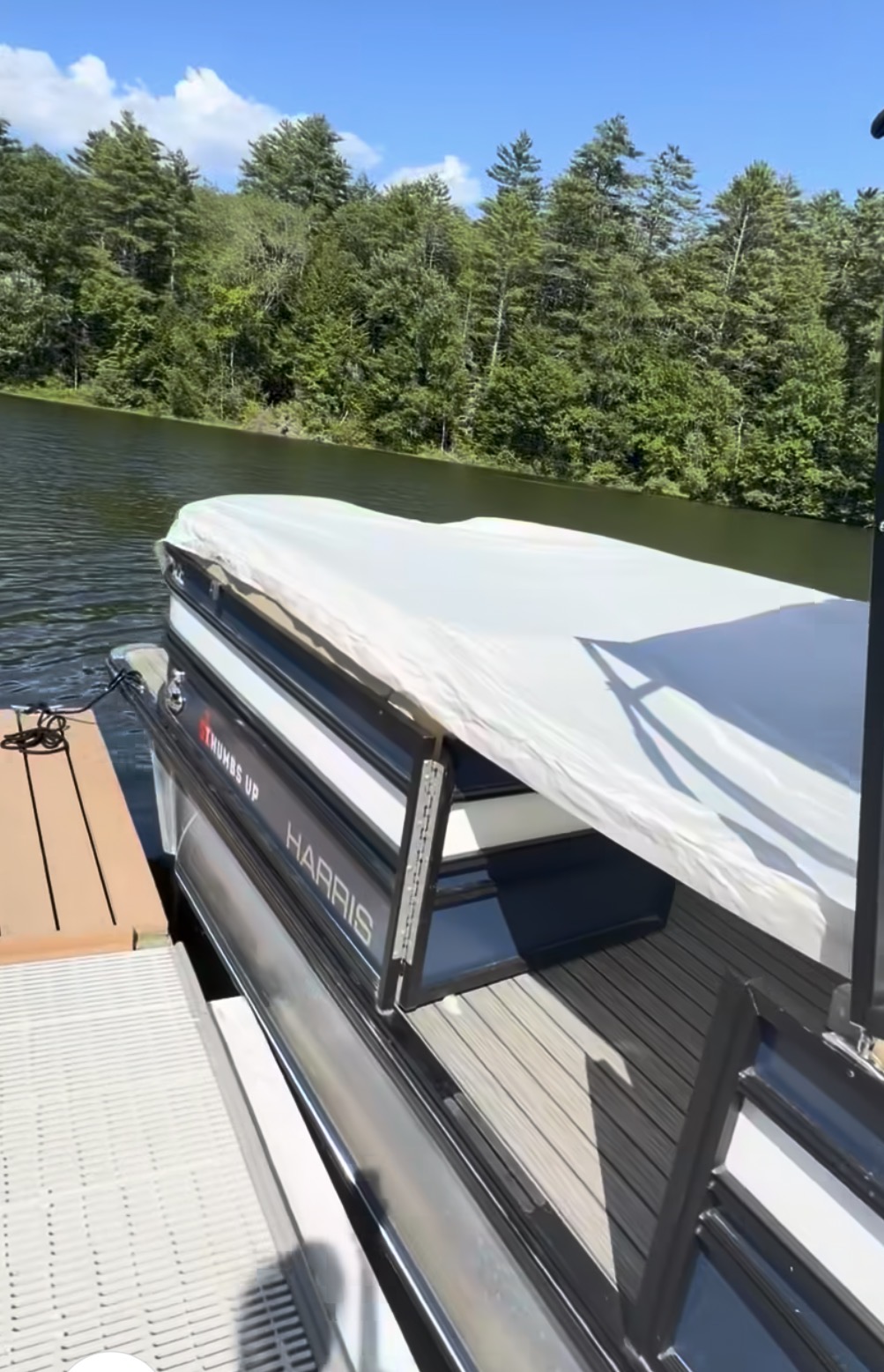 Lightweight white pontoon boat cover stretched over the seating area