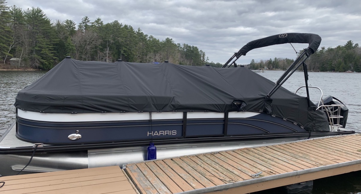 Black heavyweight storm cover fully installed on a Harris pontoon boat